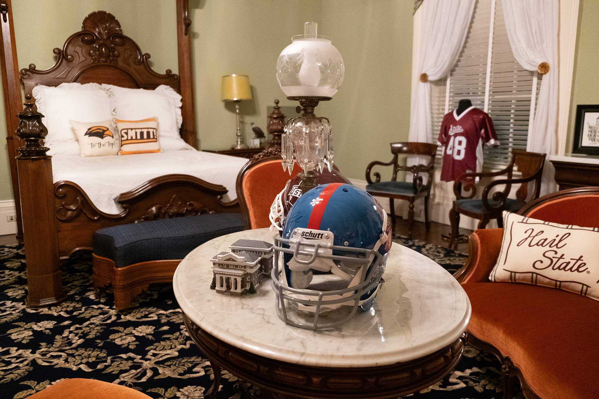 An interior view of the Mississippi Governor's Mansion, decorated for Christmas with sports items decorating the bedroom furniture