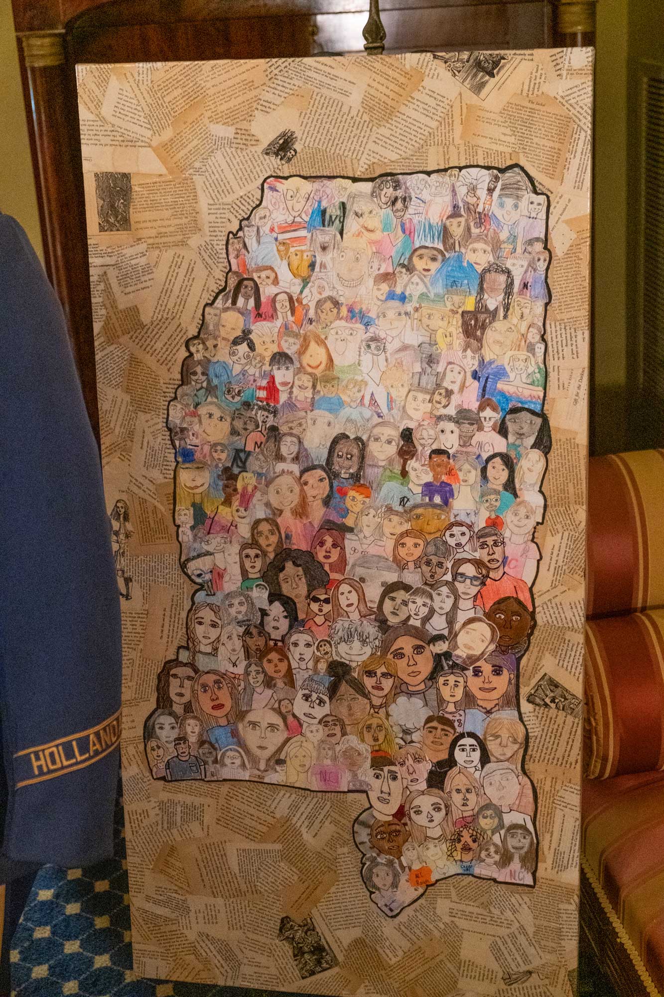 Closeup of a piece of art depicting the state of Mississippi made up of various faces of different colors
