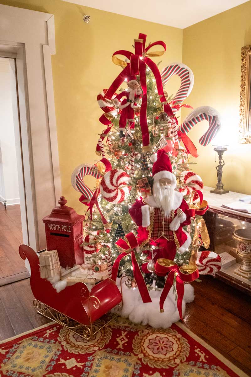 An interior view of the Mississippi Governor's Mansion, decorated for Christmas with a tree icovered in pepperments and santa clause
