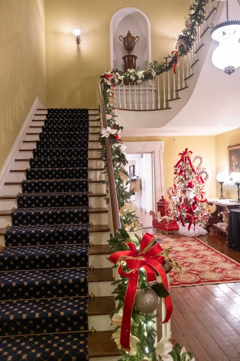 An interior view of a stairway in the Mississippi Governor's Mansion, decorated for Christmas