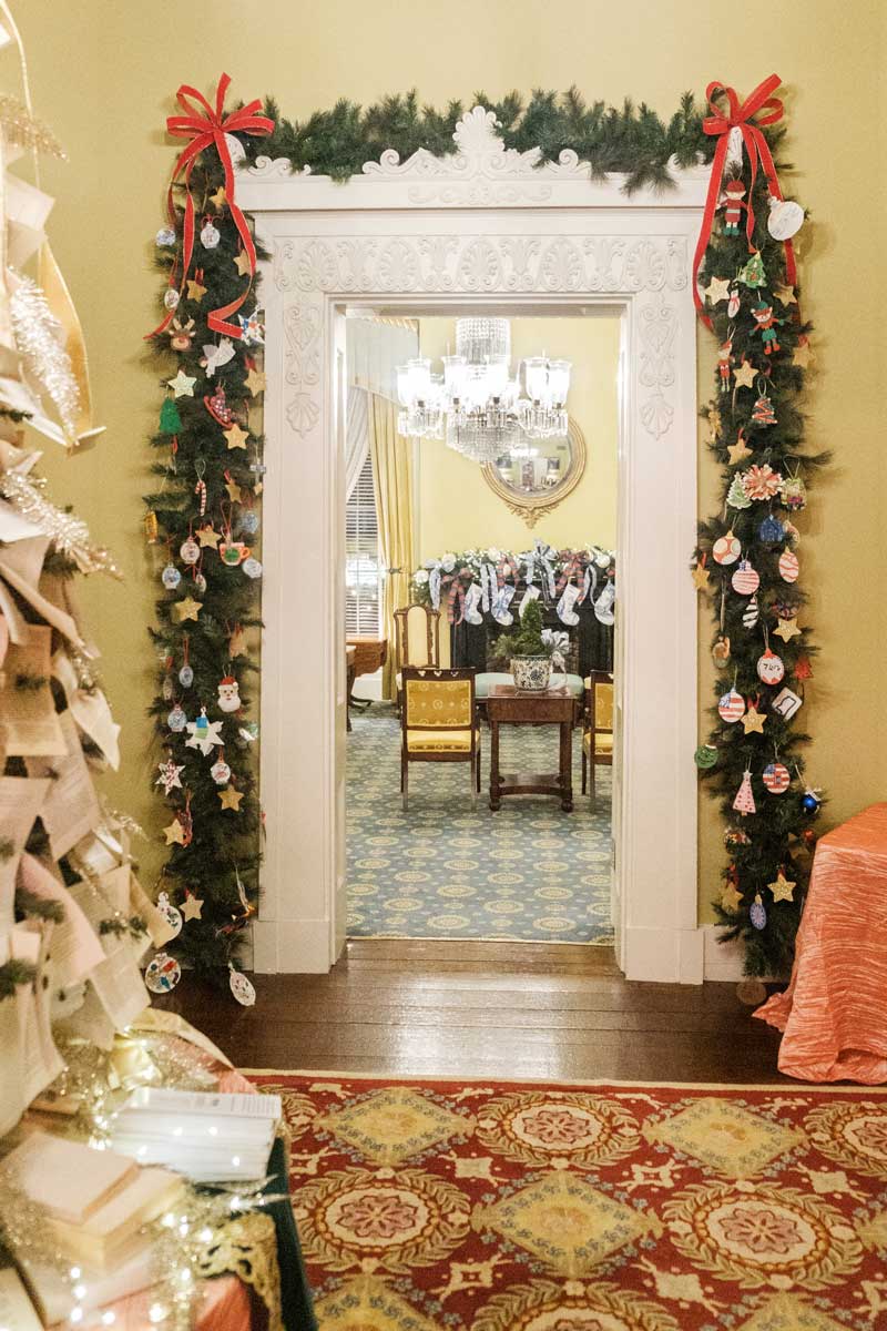 An interior view of the Mississippi Governor's Mansion, decorated for Christmas with decorations hanging around a doorway