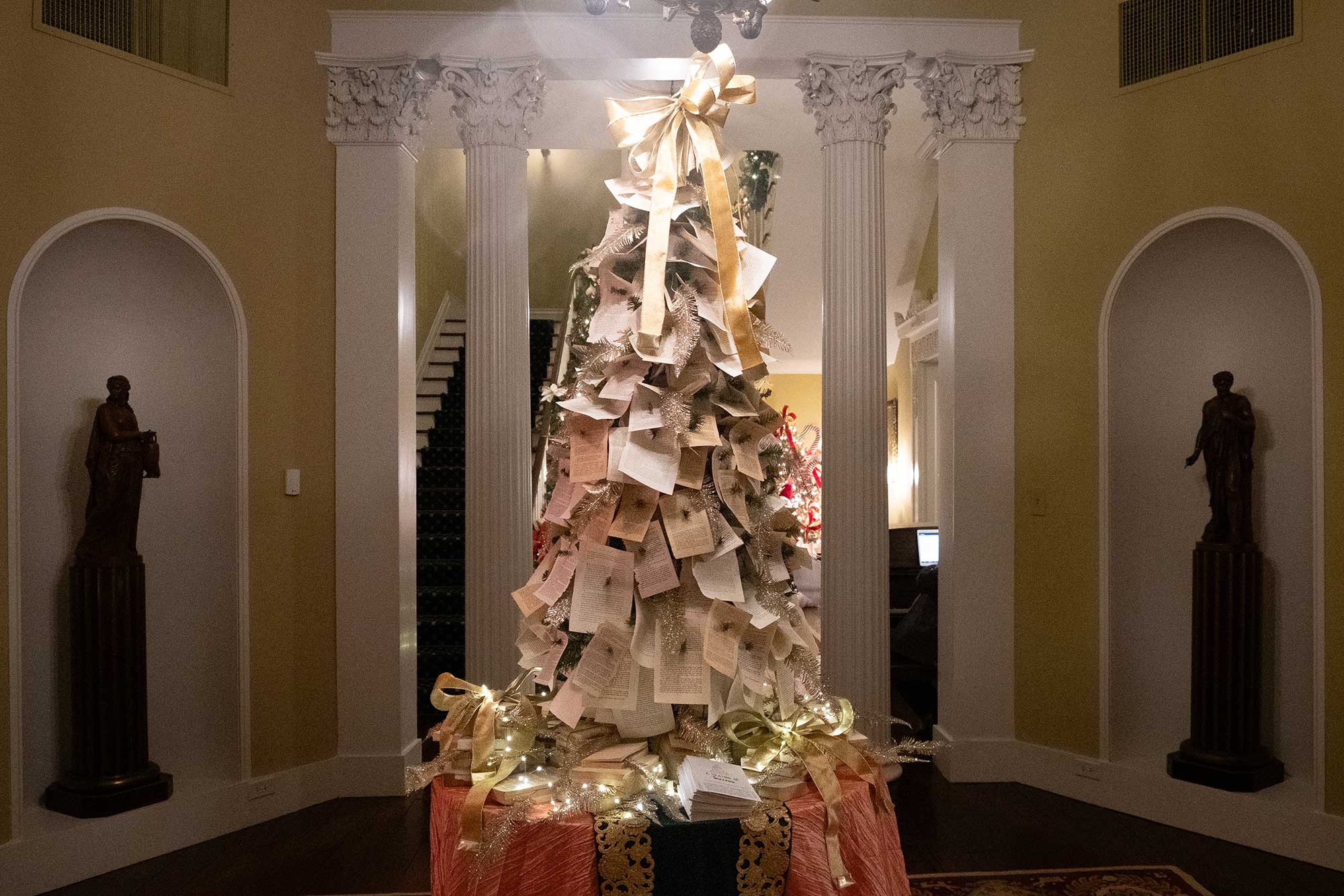 An interior view of the Mississippi Governor's Mansion, decorated for Christmas with a tree covered in pages of a book