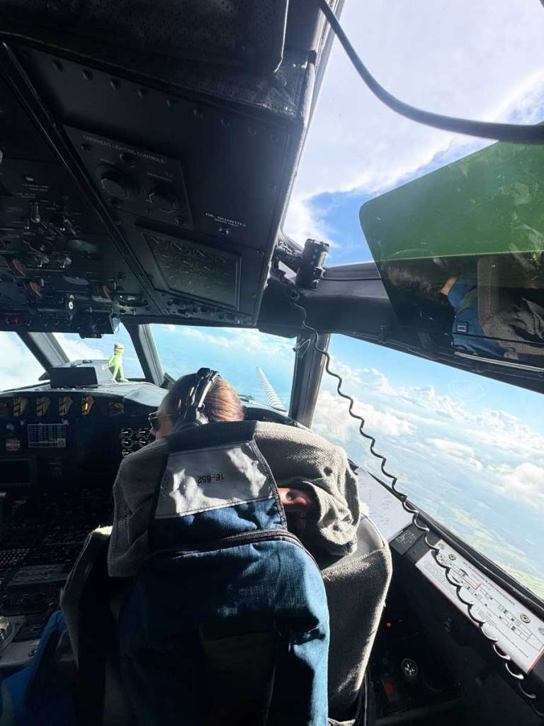 A view from behind a pilot flying an airplane