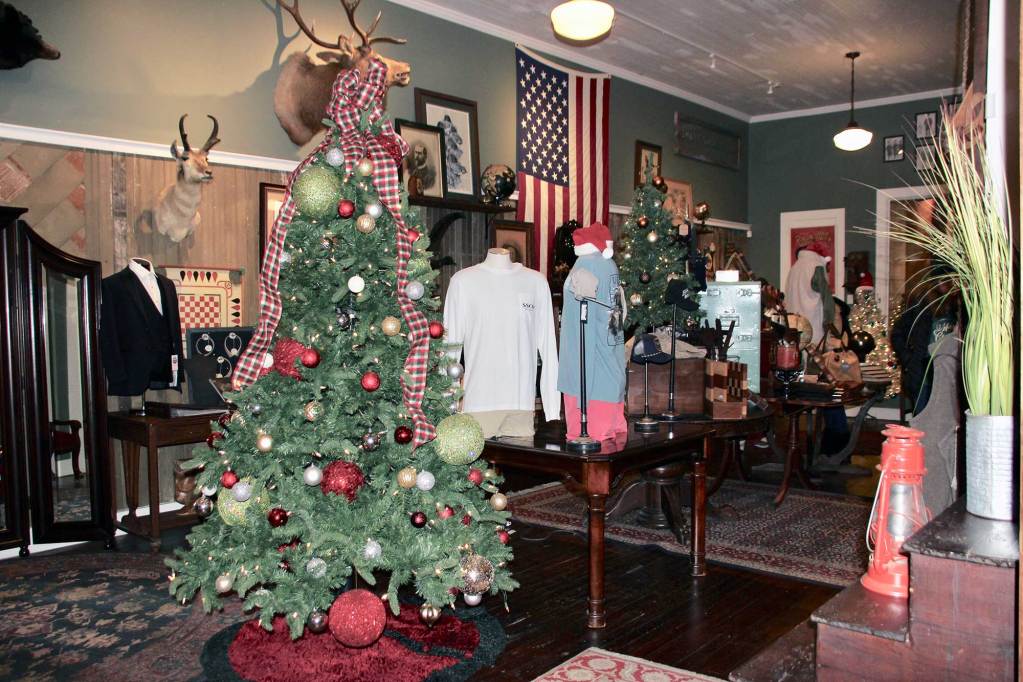A retail shop has a fully decorated Christmas tree