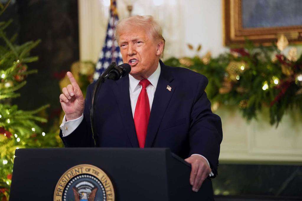Donald Trump speaking at a podium in the White House