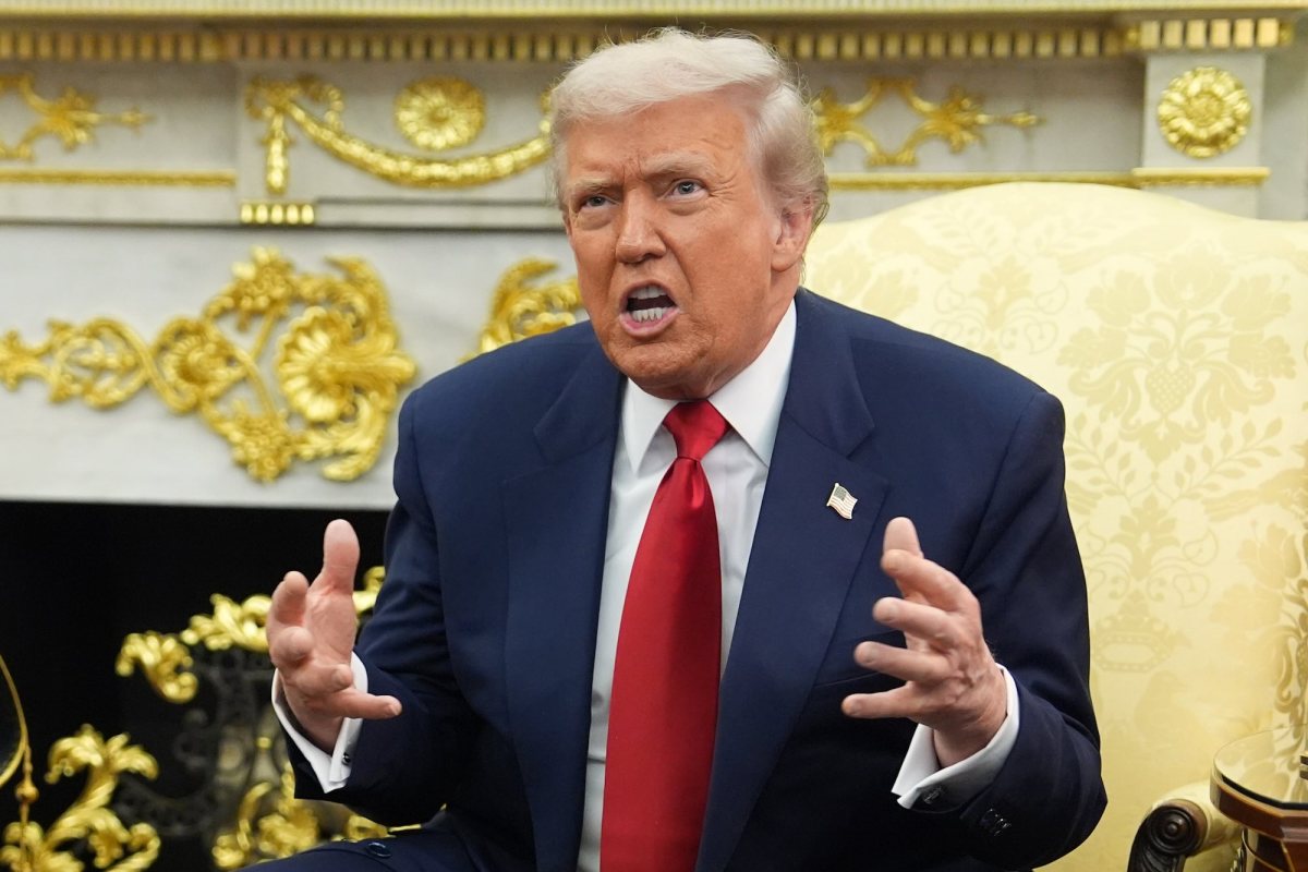 Trump sitting in a room covered in gold holding his hands up and looking frustrated.