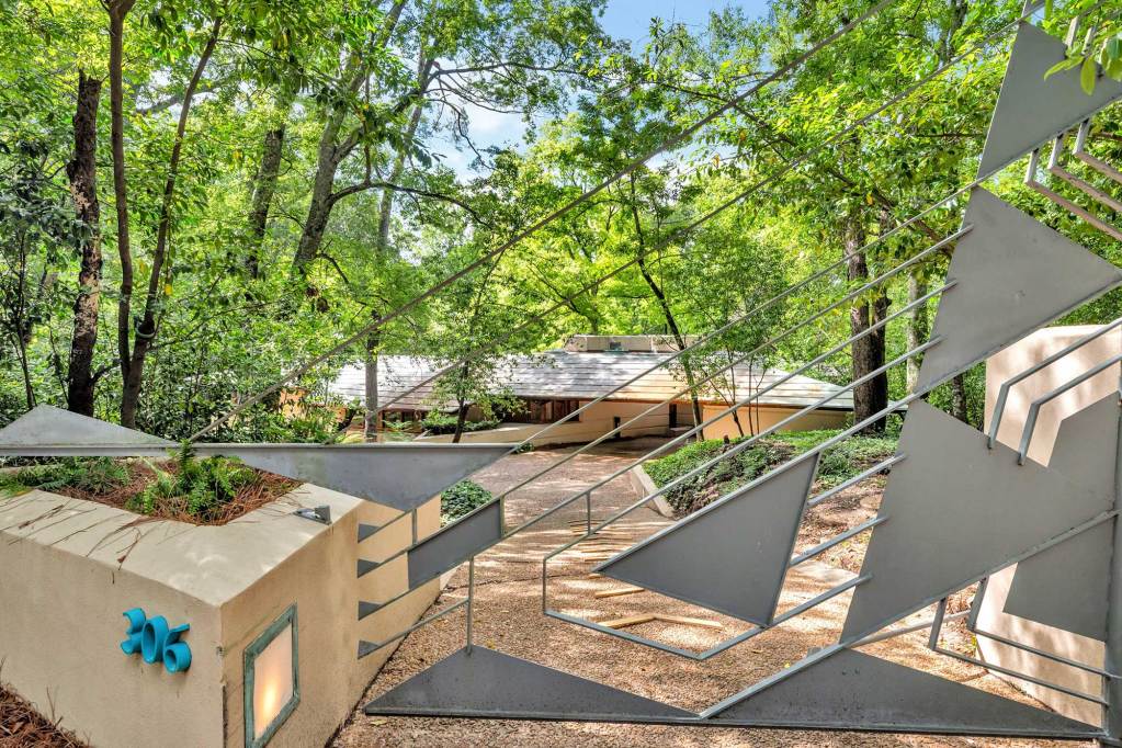 A view of the Fountainhead home from the street, with a geometric fence