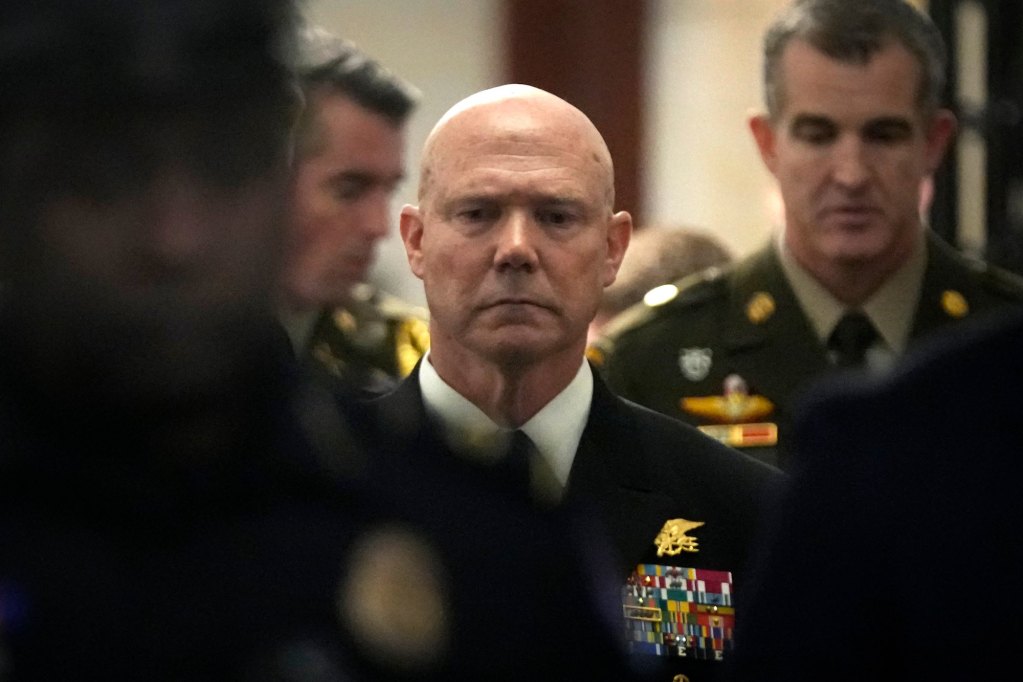 Frank M. Bradley standing in a crowd of people and looking toward the camera.