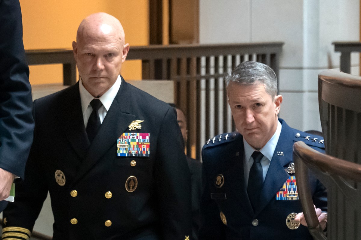 Frank M. Bradley and Dan Caine, both wearing full dress uniforms, walking upstairs.