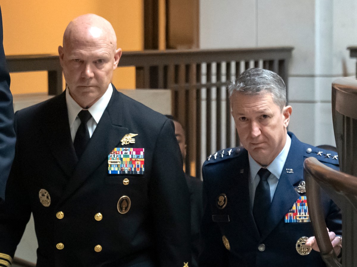 Frank M. Bradley and Dan Caine, both wearing full dress uniforms, walking upstairs.