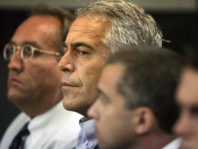 Jeffrey Epstein sitting in a row of men in a court room