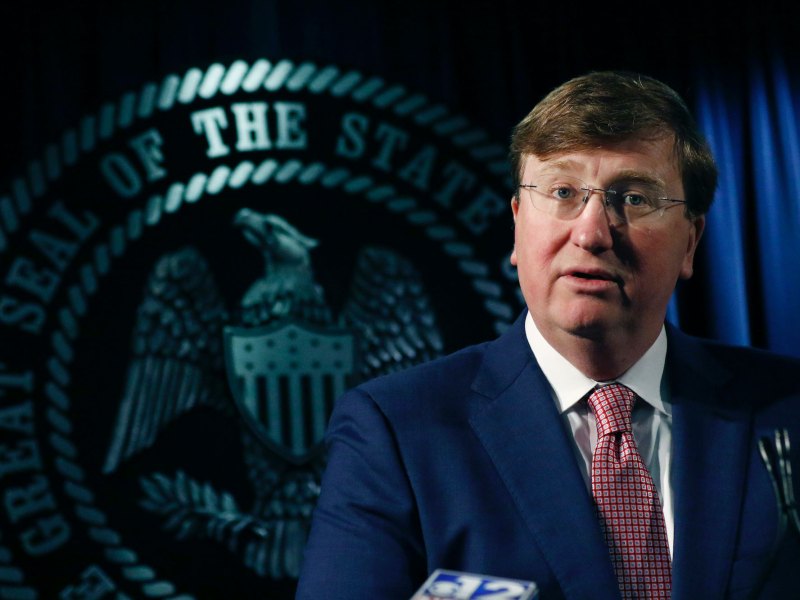 Mississippi governor state reeves speaking at a podium in front of a state seal