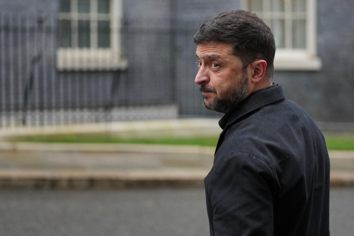 Volodymyr Zelenskyy looking back over his left shoulder