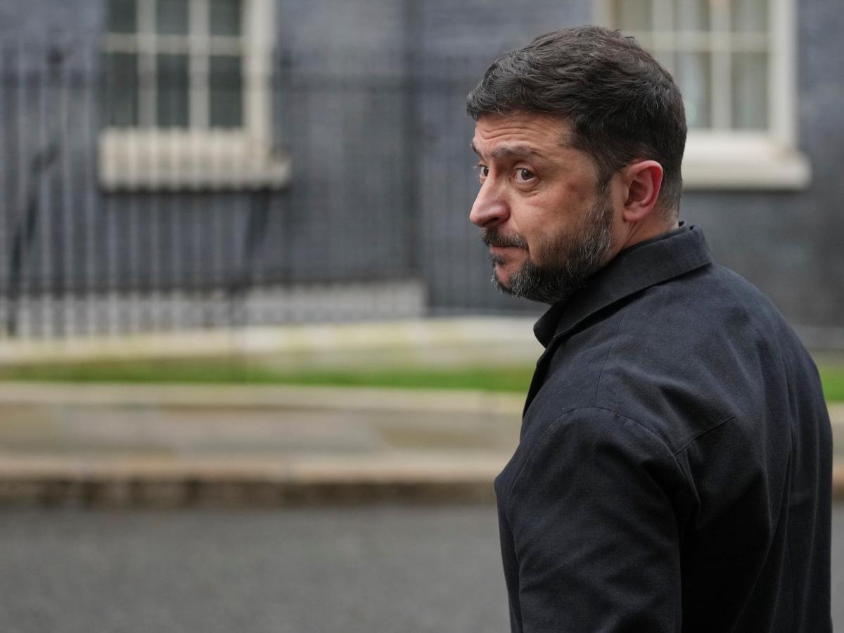 Volodymyr Zelenskyy looking back over his left shoulder