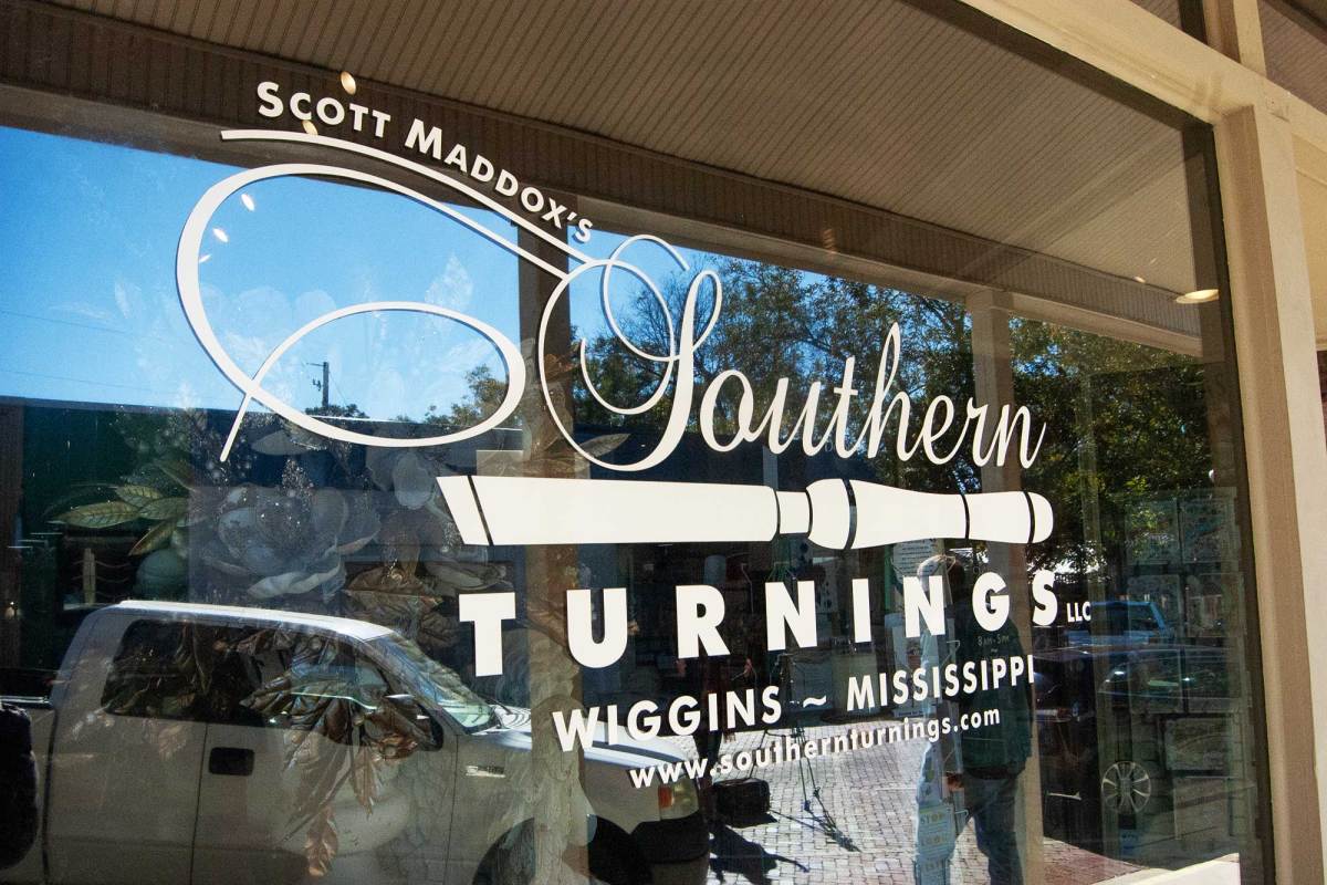 The Southern Turnings logo and name appear on a storefront window reflecting the street outside.