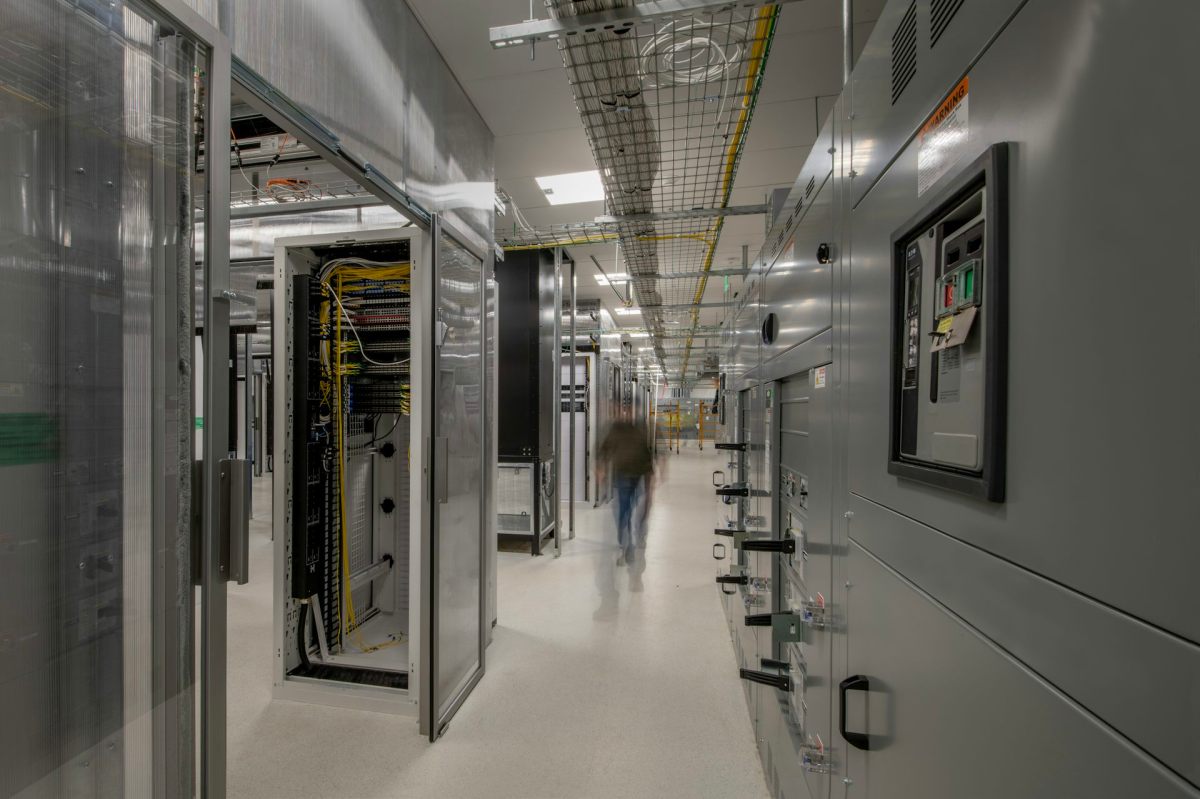 The interior of a data center, with one module’s casing removed exposing its internal circuitry and wiring.