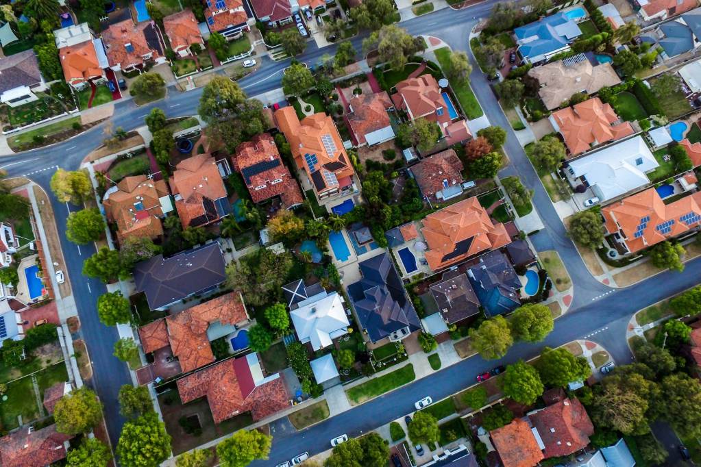 An overhead shot of a neighborhood with a variety of houses