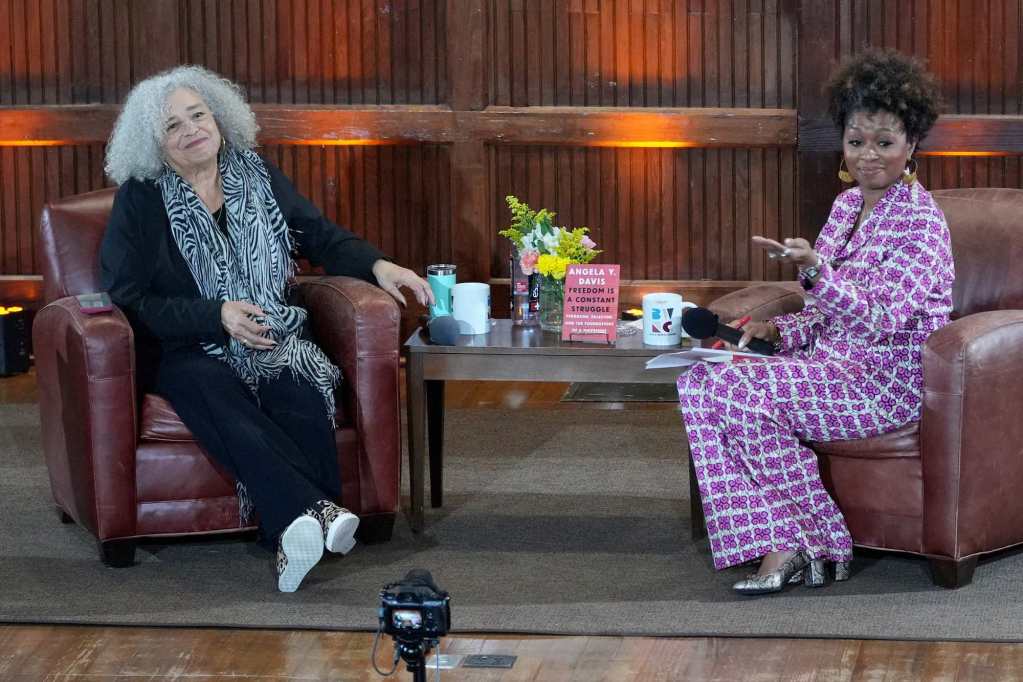 Angela Davis, moderated by Ebony Lumumba, listens to an audience member
