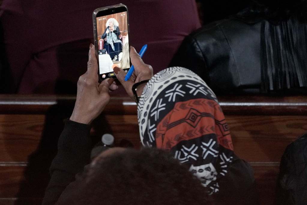 An audience member recording Angela Davis speak