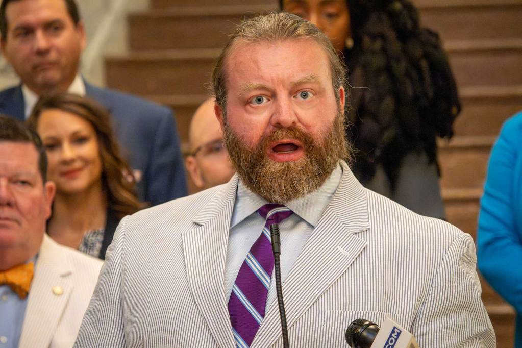 Bryan Hubbard standing and speaking at a press conference