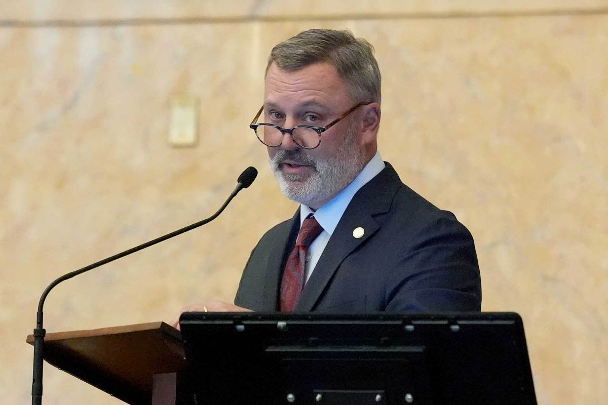 With round glasses perched on his nose, Jason White speaks into a microphone at the speaker’s dais in the House chamber