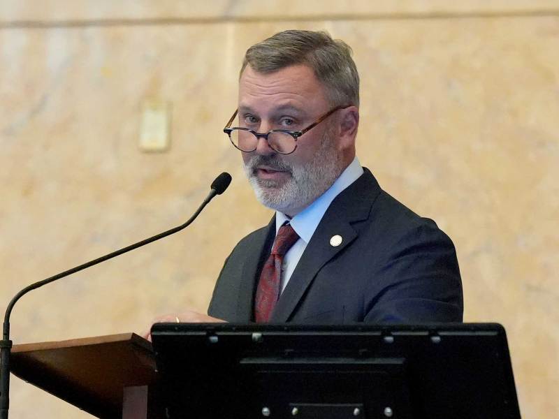 With round glasses perched on his nose, Jason White speaks into a microphone at the speaker’s dais in the House chamber
