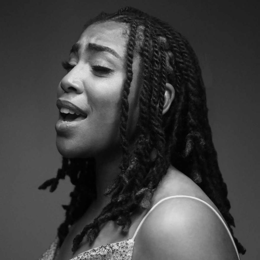 A black and white photo of a woman singing