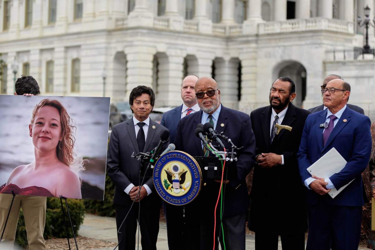 Bennie Thompson speaks at a press conference beside a photo of Renee Nicole Good