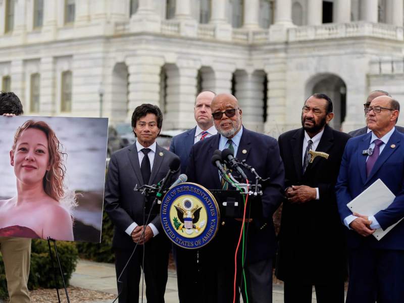 Bennie Thompson speaks at a press conference beside a photo of Renee Nicole Good