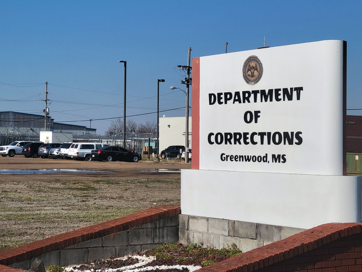 An outdoor sign reading 'Department of Corrections Greenwood, MS'