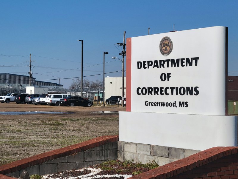 An outdoor sign reading 'Department of Corrections Greenwood, MS'