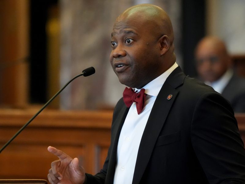Derrick Simmons seen speaking at the legislature, one hand gesturing as he speaks
