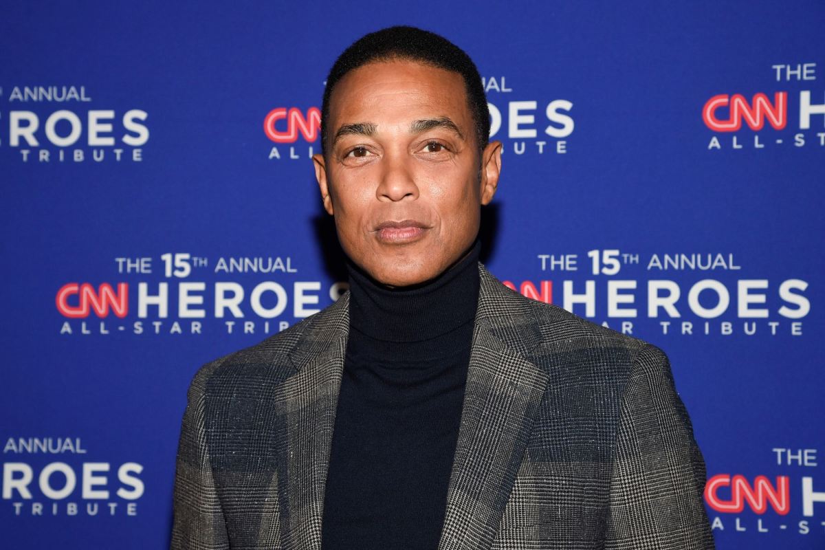 Don Lemon standing in front of a blue wall covered in logos for 'The 15th Annual CNN Heroes All-Star Tribute'