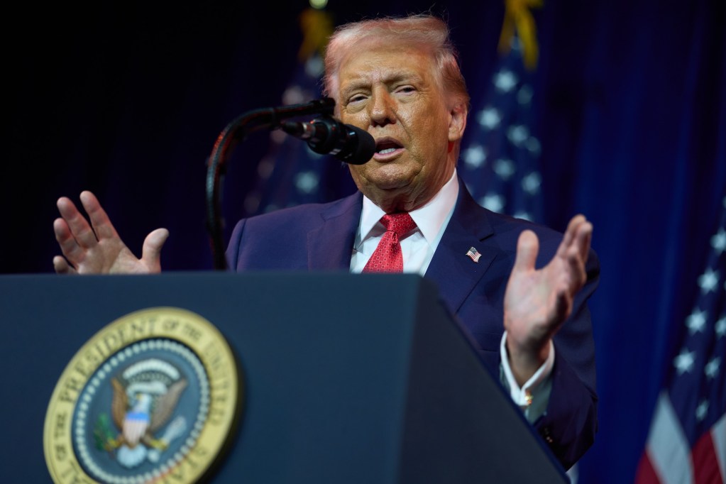 Donald Trump speaking at a podium.