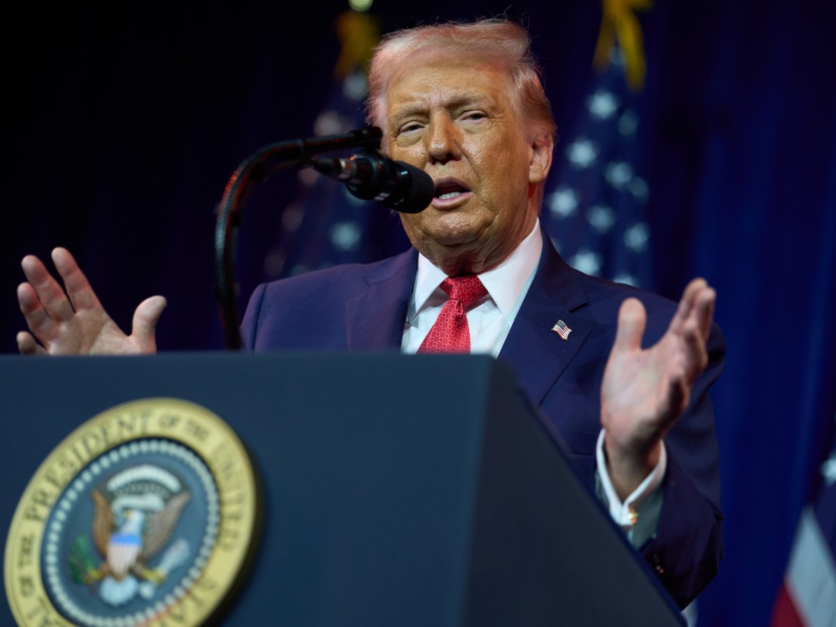 Donald Trump speaking at a podium.