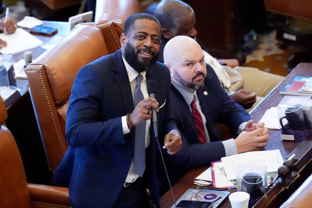 Fabian Nelson smiles as he looks up in the gallery of the senate chambers