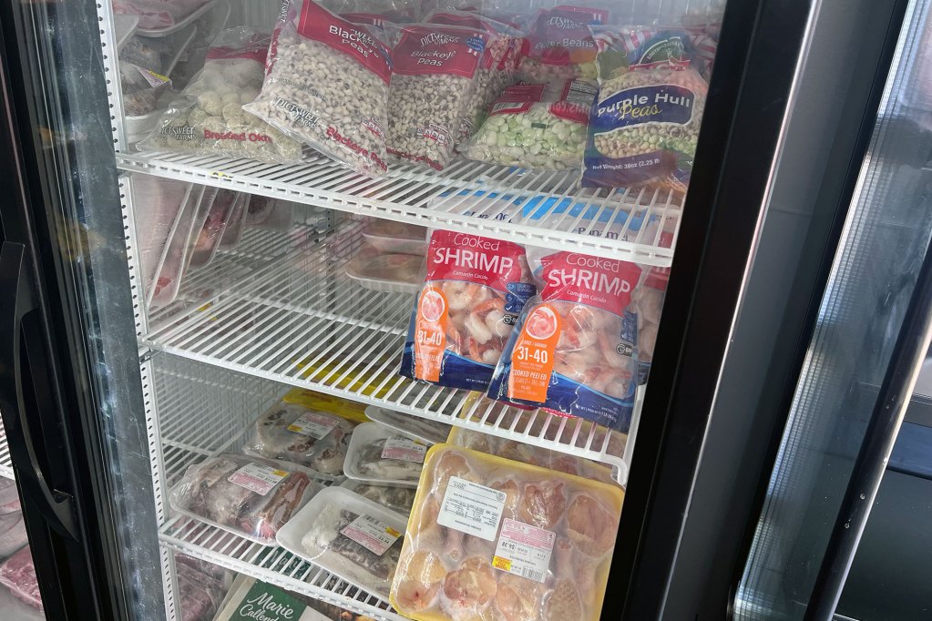a freezer of frozen vegetables and meat