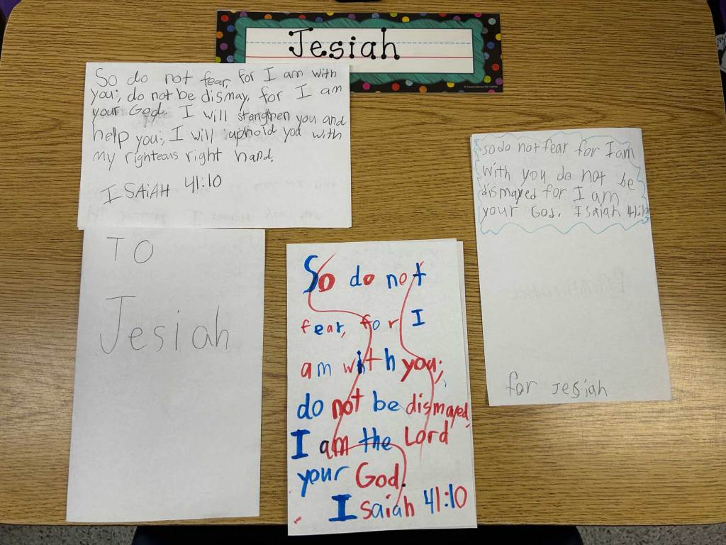 Four notes written by school children on a school desk