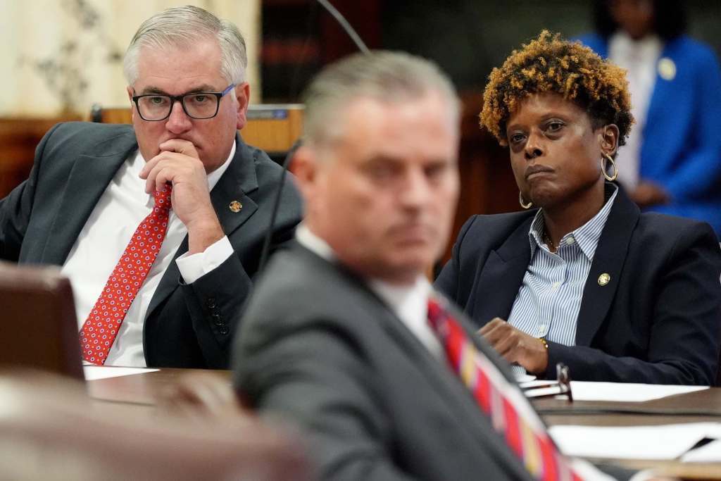 Mike Johnson and Sarita M. Simmons listen at the legislature