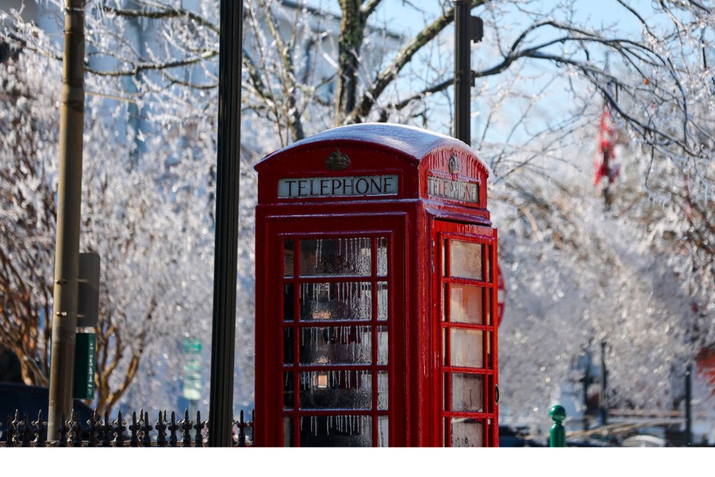 a frozen red British telephone booth