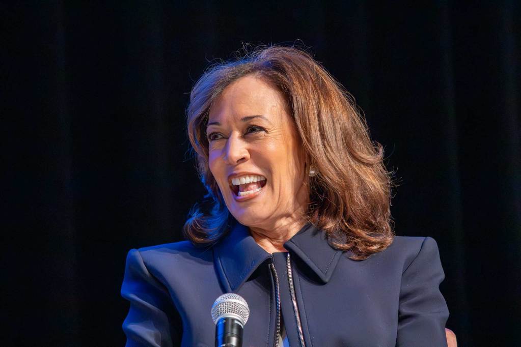 A closeup of Kamala Harris smiling on stage