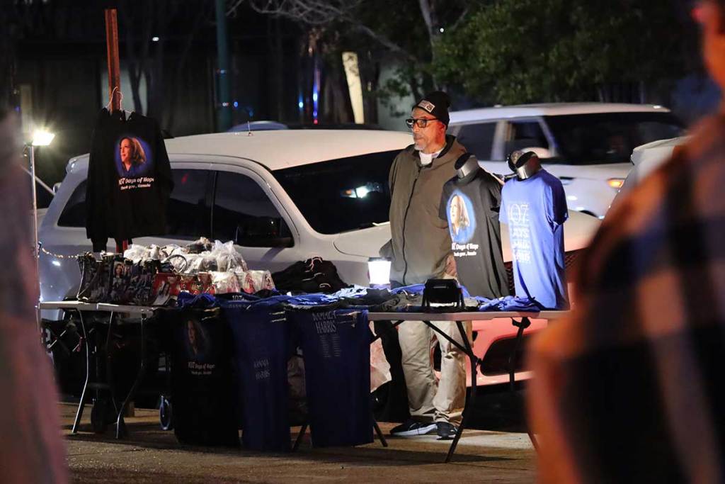 Man selling Kamala Harris merchandise outside of an event venue