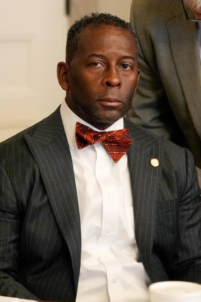 Christopher Bell, in suit and bowtie, listenings at the capitol