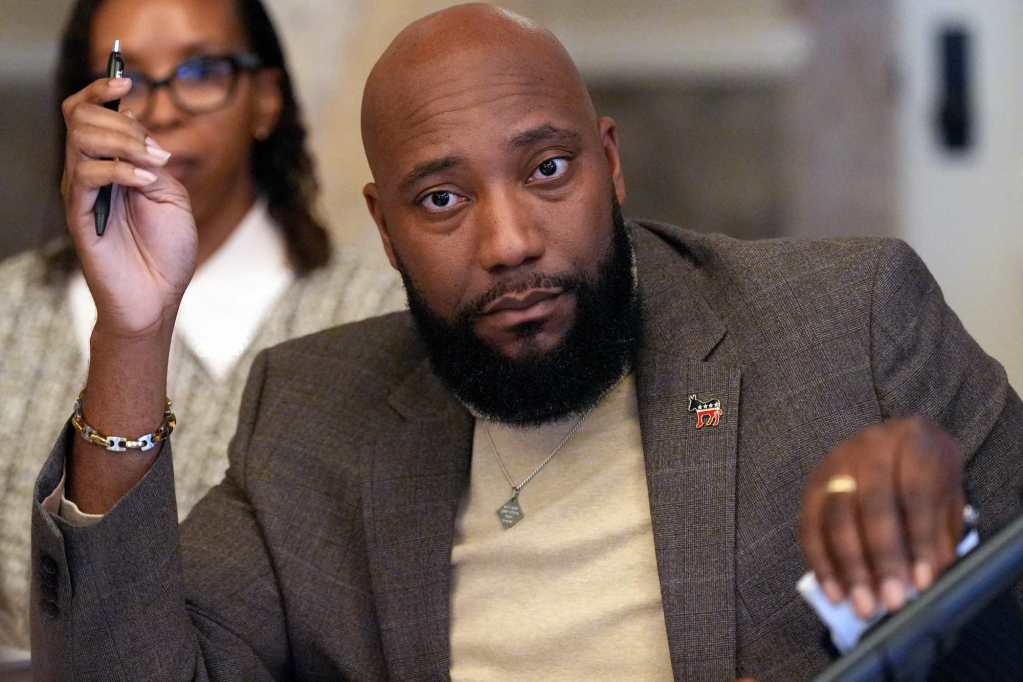 Daryl Porter raises a hand that’s holding a pen.