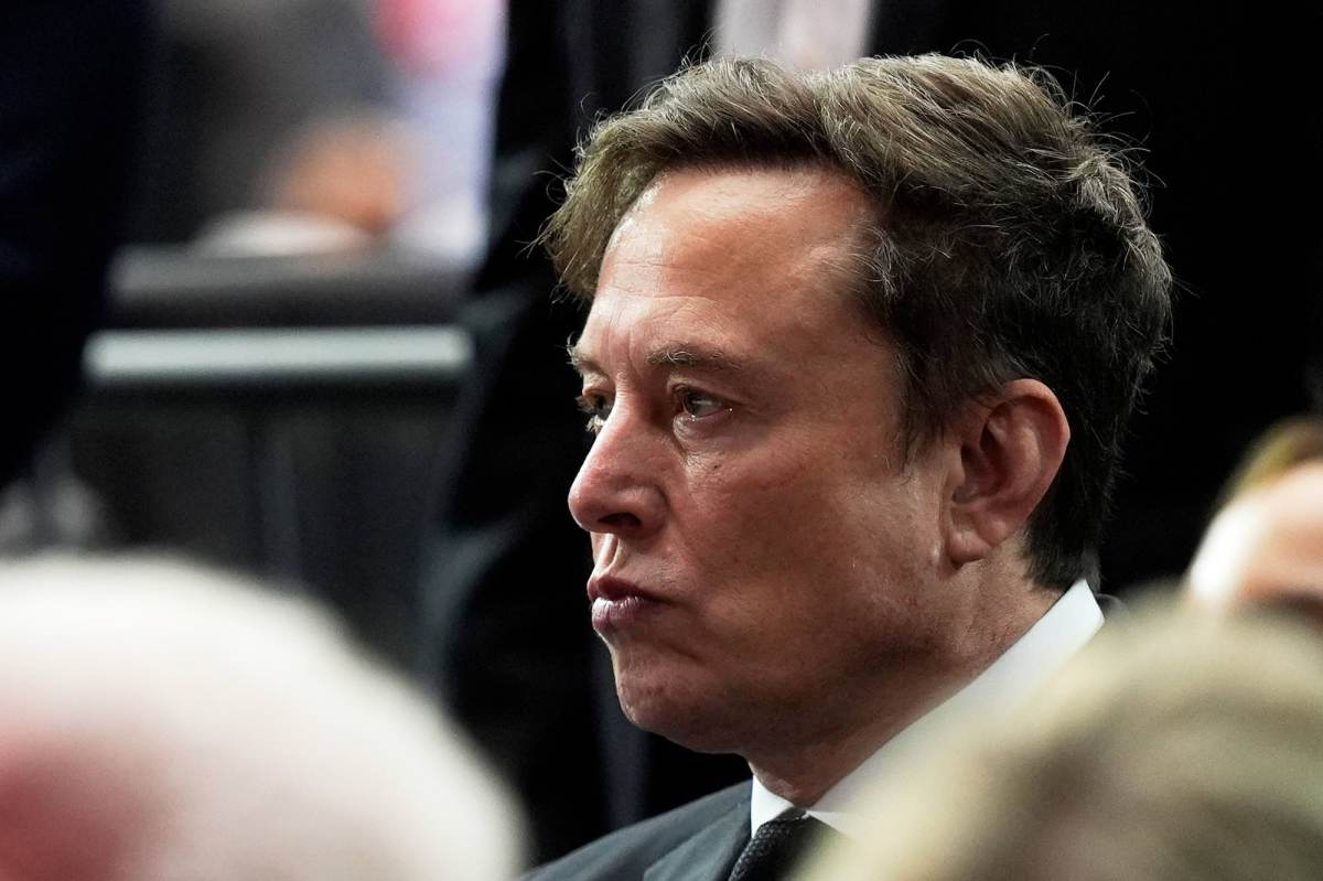 A closeup of Elon Musk at a memorial
