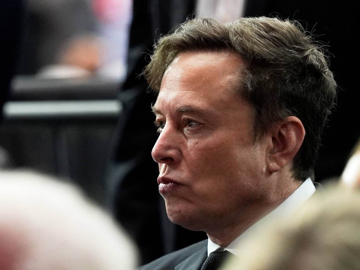 A closeup of Elon Musk at a memorial
