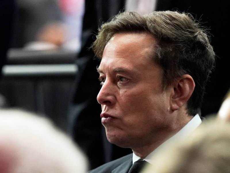 A closeup of Elon Musk at a memorial