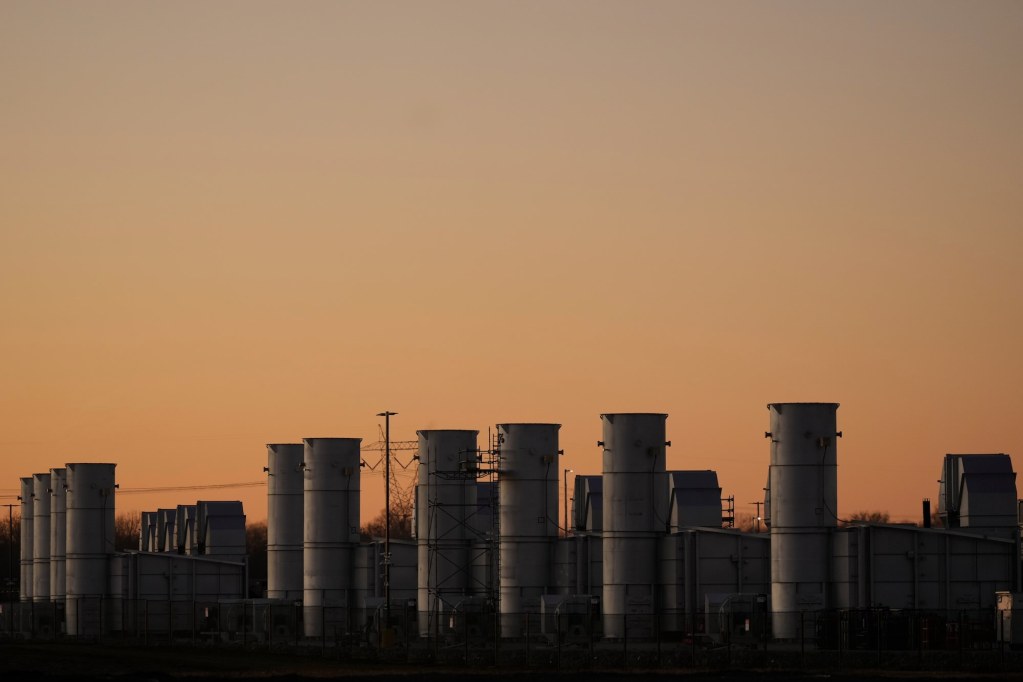 A view of a long row of gas turbines seen at sunset