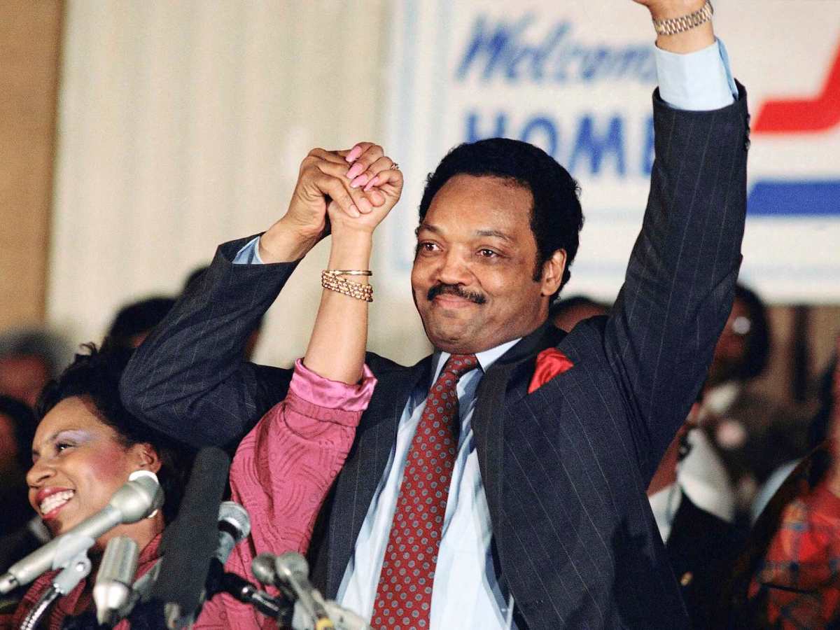 Jesse Jackson and his wife Jacqueline raise their hands proudly at an election party