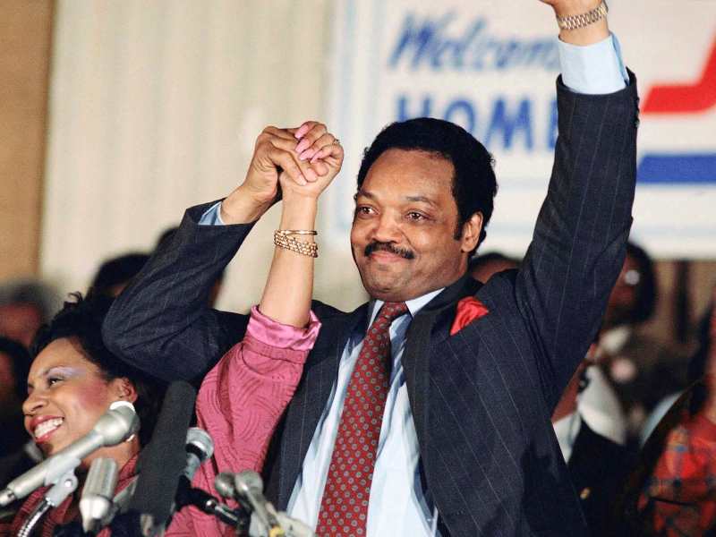 Jesse Jackson and his wife Jacqueline raise their hands proudly at an election party